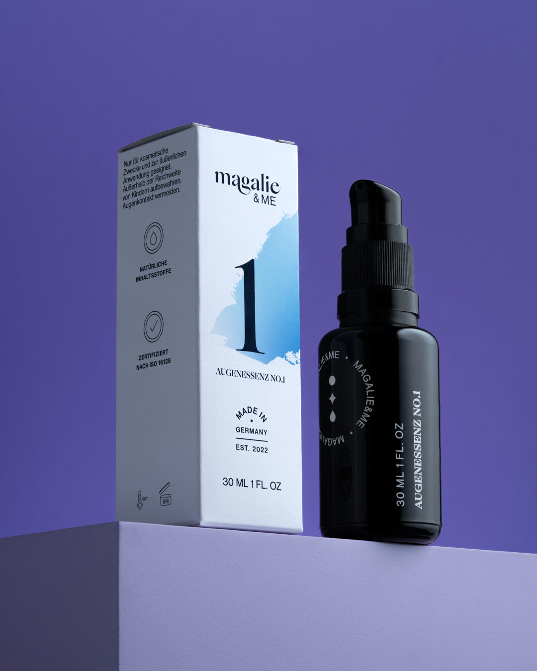 Schwarze Flasche und weiße Box eines Augenserums mit der Aufschrift "magalie & ME" auf lilafarbenem Hintergrund.